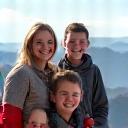 The Fischer Family smiling on a mountain top